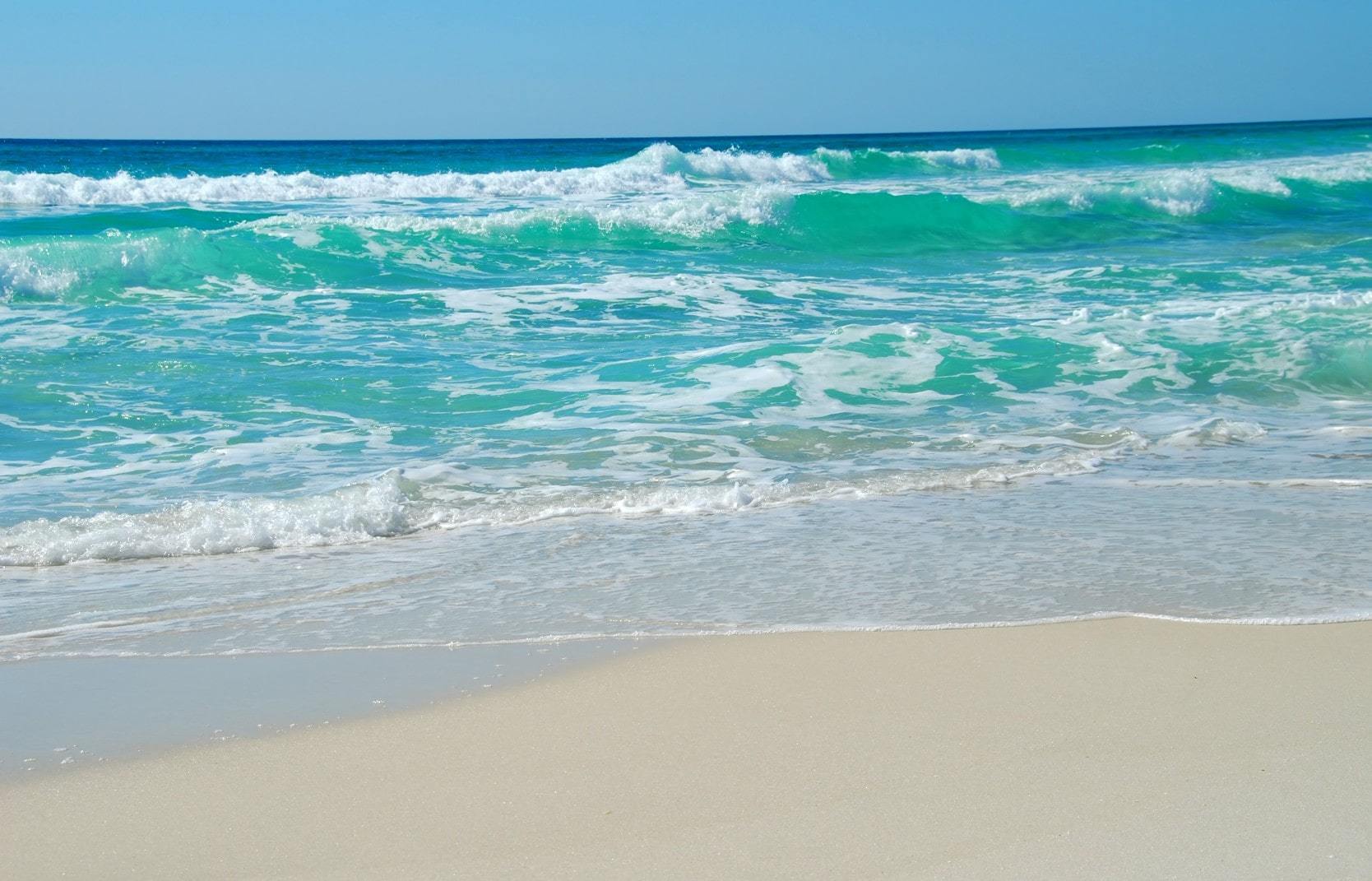 Turquoise water with waves on a white sand beach on Florida's Gulf Coast