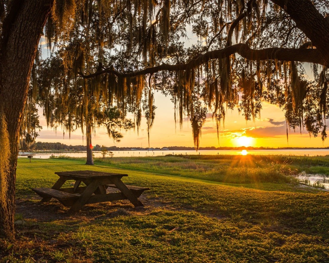 Picnic table in front of a lake at sunset in Claremont, Florida