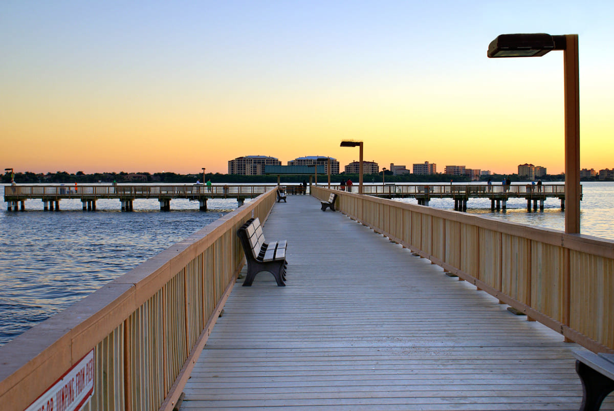 An evening view of a Cape Coral, FL beach on a pier.