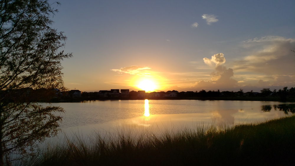 Sunset over a lake and waterfront homes in Lake Nona, Florida